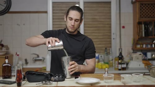 Man Preparing Cocktail Drink With a Shaker