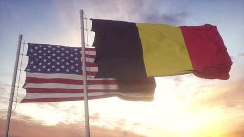 USA and Belgium Flags Waving Together at Sunset