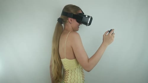 Woman Using VR Headset with Controller Indoors