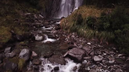 Aerial View of Breathtaking Waterfall in Lush Nature
