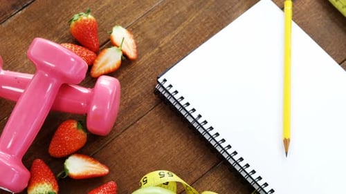 Healthy Food and Exercise Items on Wooden Surface