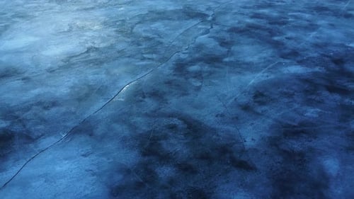 Aerial drone view to lake frozen water.