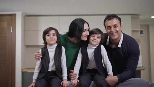 Happy Family Poses for Portrait Indoors Together