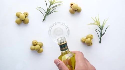 Pouring Fresh Olive Oil in Small Container