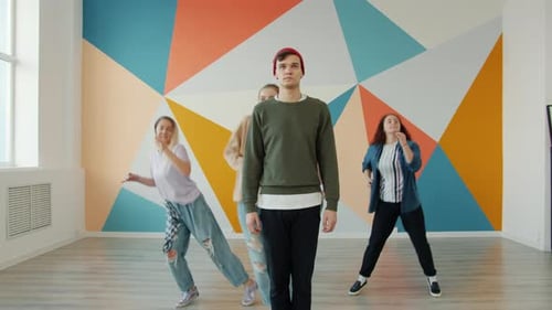 Talented Young People Performing Modern Dance in Studio Practicing Indoors