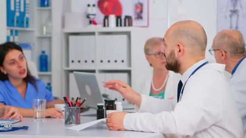 Medical Professionals Collaborate in Hospital Conference Room