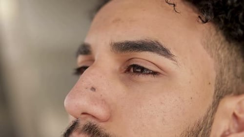 Close Up Profile of Man with Black Curly Hair