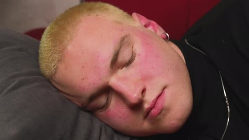 Close Up Young Homosexual Man Came Home After Work Flopped Down on Sofa at Home