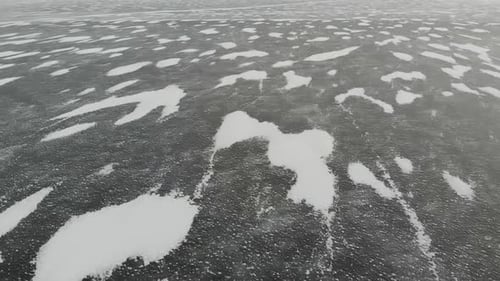 Aerial Perspective View of Beautiful Ice Textured Frozen Baikal Lake Surface From Above Captured