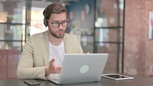 Man on Video Call in Modern Office