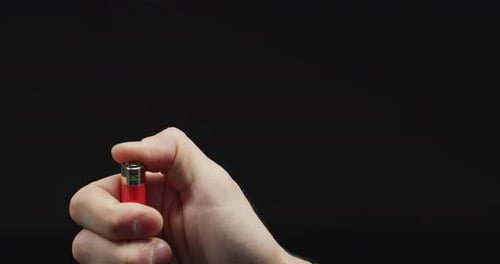 Hand igniting a lighter