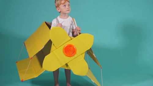 Lovely Boy 5 Jahre alt im gelben Pappflugzeug