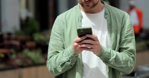 Man Using Smartphone Outdoors in Urban Environment