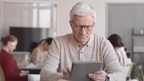 Man Using Tablet Computer in Office