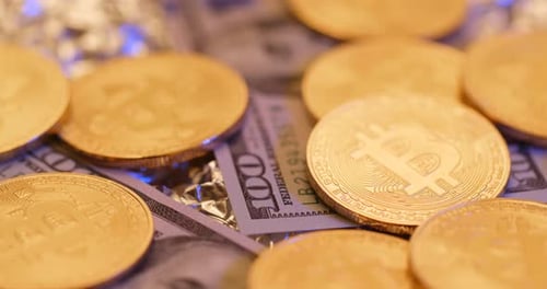 Gold Bitcoin Coins on Dollar Bills