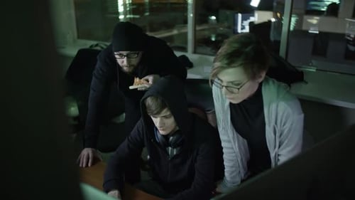 Team Works Late at Night on Computers