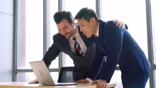 Two Happy Business People Celebrate at Office