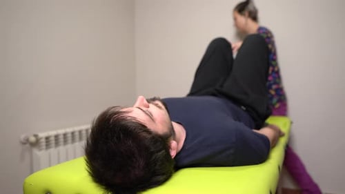 Man Receiving Knee Therapy From Woman