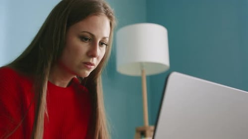 Brunette Woman Works at Laptop and Drinks Coffee