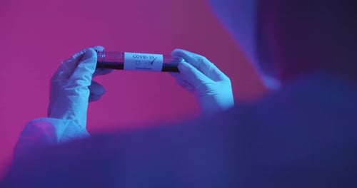 Scientist Examines Blood Sample in Lab