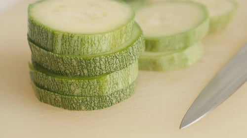 Cuts of organic zucchini on pile close-up 4K 2160p 30fps UltraHD tilting footage - Pepo cylindrica