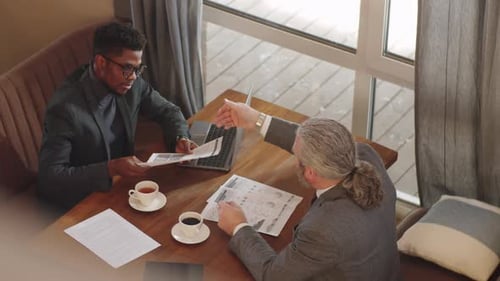 Multiethnic Male Business Partners Having Meeting in Restaurant