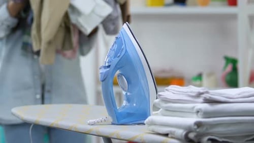 Young Adult Carries Large Pile of Laundry