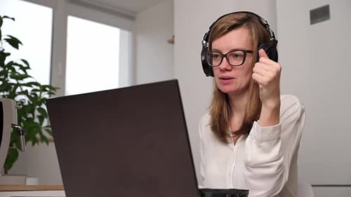 Woman Video Calling with Laptop in Home Office