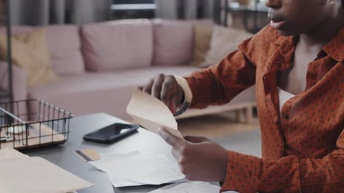Woman Opens Mail At Desk