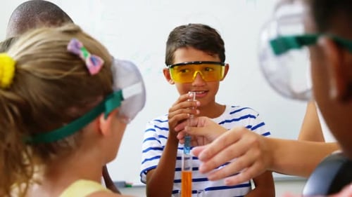 Teacher assisting kids in laboratory