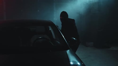 Masked Person Approaches Car at Night