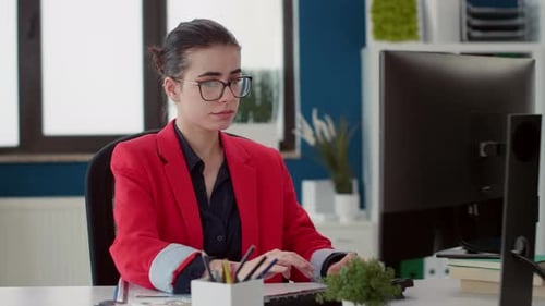 Business Woman Using Computer to Work in Startup Office
