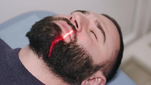 Man Laying at Doctor's Office Being Medically Scanned
