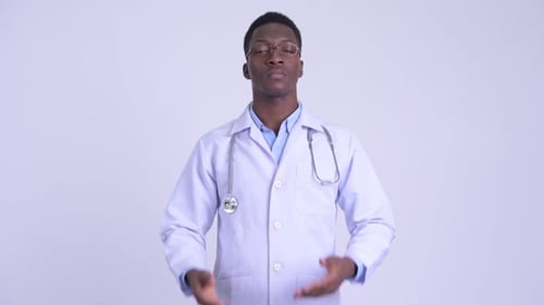 Young Doctor in White Coat Covers Mouth