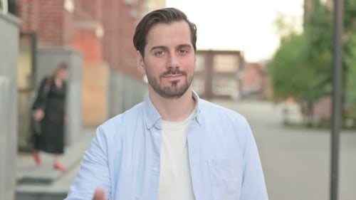 Young Adult Man Giving Thumbs Up Gesture