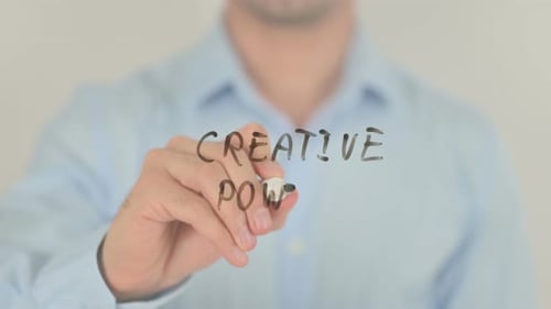 Writing the Words Creative Power on Glass