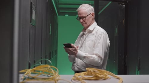 Man Uses Phone in Modern Data Center