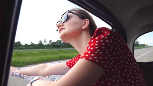Woman Enjoying Car Ride Through Countryside