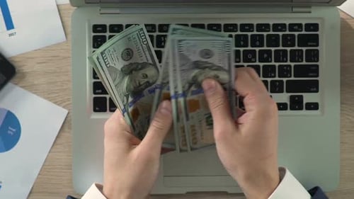Close-Up of Businessperson Counting Dollar Banknotes at Workplace, Slow-Motion