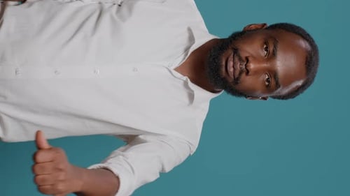 Adult Man Giving Thumbs Up on Blue Background