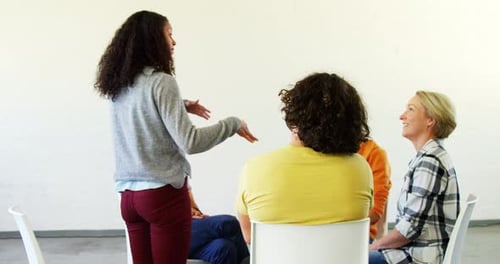 Group Meeting with Woman Speaking in Bright Room