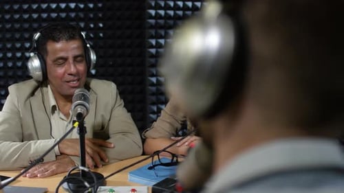 Man and Woman Chatting with Radio Host in Studio