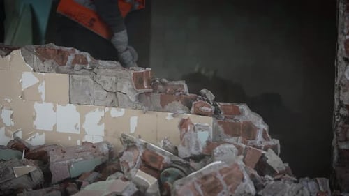 Dismantling an Unnecessary Brick Wall During Construction Work in an Old Building