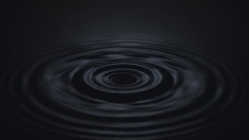 Water Drop Creates Ripples in Dark Liquid