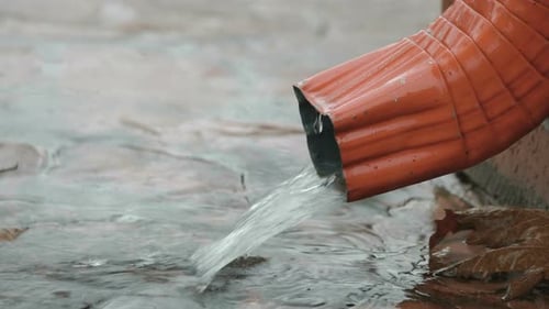 Rain Water Flows From the Gutter