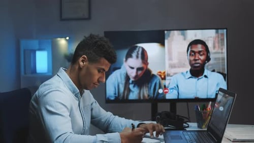Close-up Shot of Black Chief Manager Making Video Call on Big Monitor with Colleagues on Quarantine