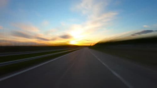 Driving along a rural road at sunset, time-lapse