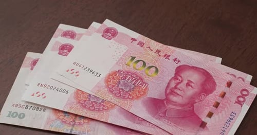 Counting Stack of Chinese Yuan Banknotes Close Up