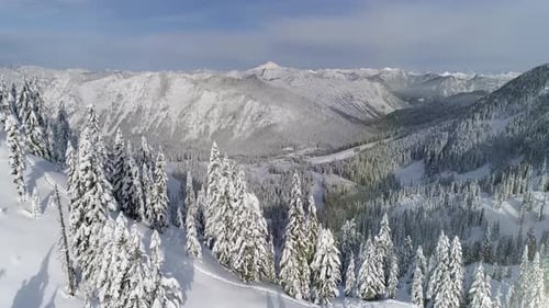 Sunny Aerial Reveal Of Winter Sports Resort In Snowy Mountain Range
