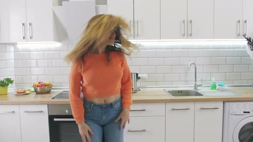 Woman Dancing and Flipping Hair in Kitchen